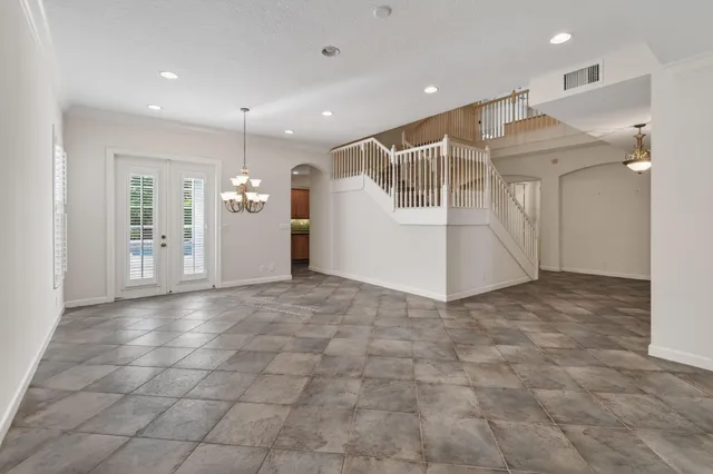 a view of a hallway with a dining table & chairs