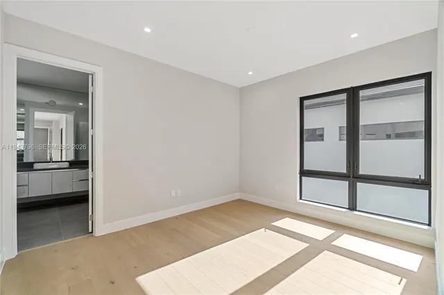 a large white bathroom with a large tub and sink