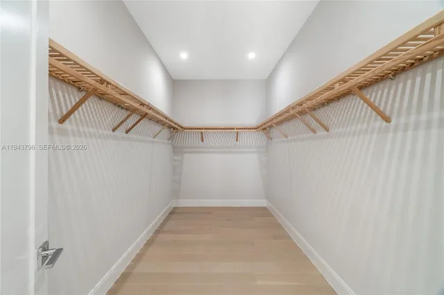 a spacious bathroom with a granite countertop sink and a large mirror