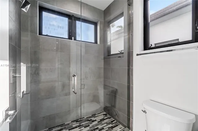 an empty room with windows and closet