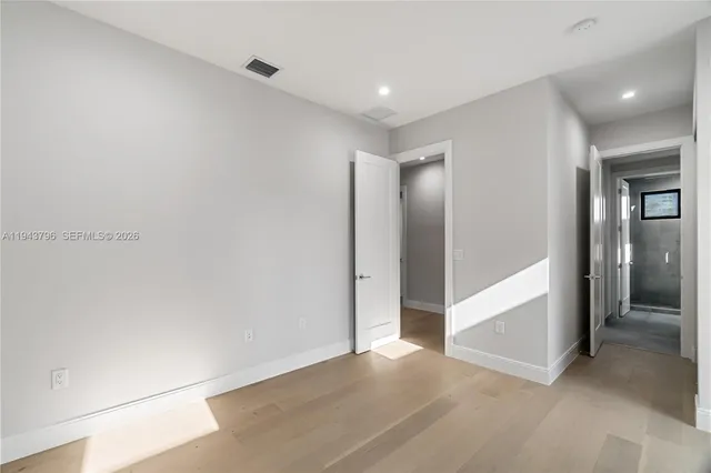 an empty room with windows and closet