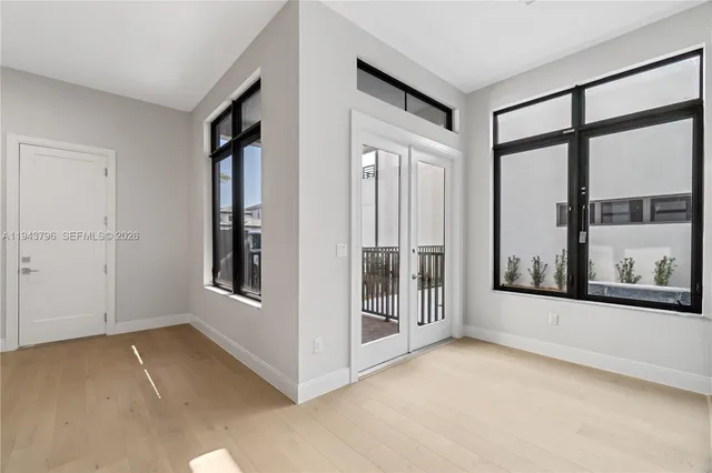 an empty room with windows and entrance