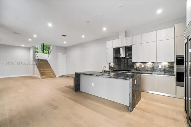 a kitchen with a sink stainless steel appliances and cabinets