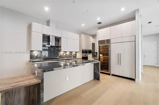 a kitchen with stainless steel appliances a refrigerator stove microwave and sink