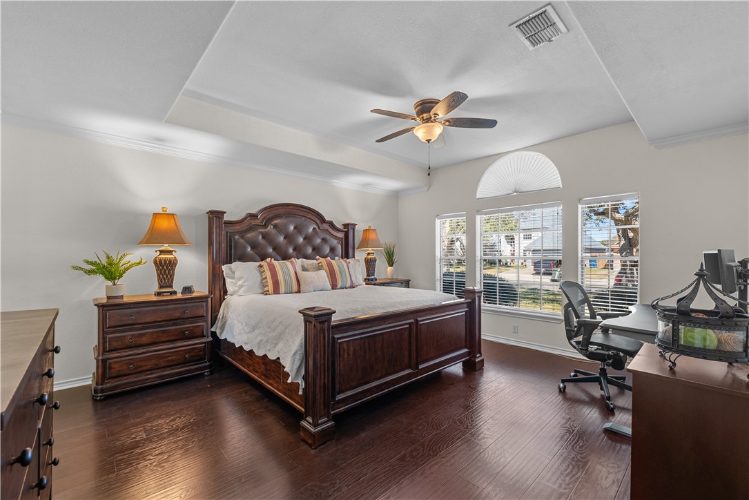 5117 Lethaby Drive Corpus Christi, TX 78413 - Photo 12 of 31 a bedroom with a bed a chandelier and dresser