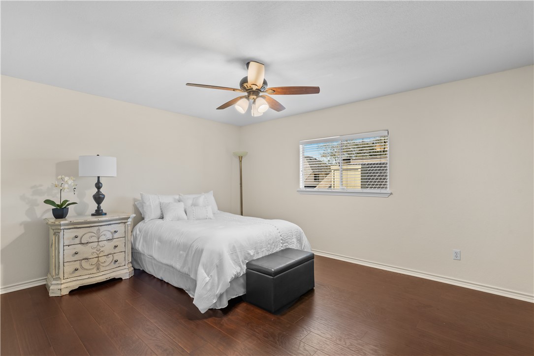 5117 Lethaby Drive Corpus Christi, TX 78413 - Photo 22 of 31 a bedroom with a bed chandelier and a window