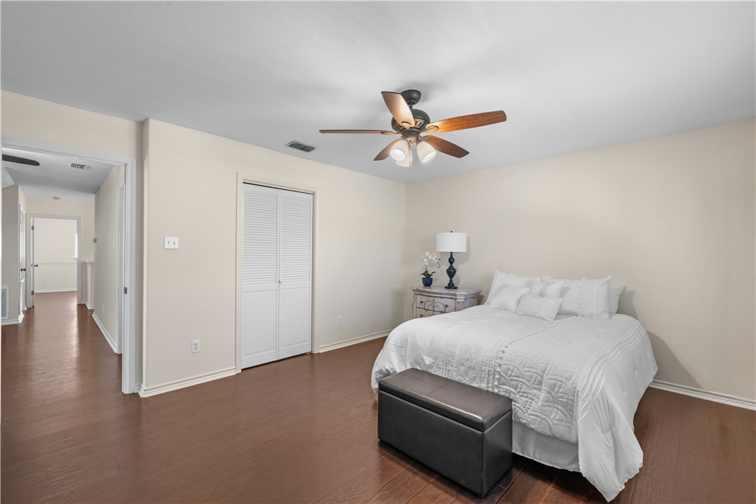 5117 Lethaby Drive Corpus Christi, TX 78413 - Photo 23 of 31 a bedroom with a bed and a chandelier