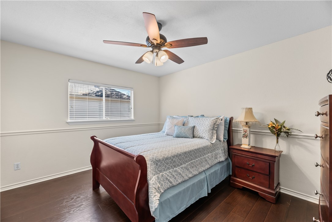 5117 Lethaby Drive Corpus Christi, TX 78413 - Photo 26 of 31 a bedroom with a bed and a chandelier