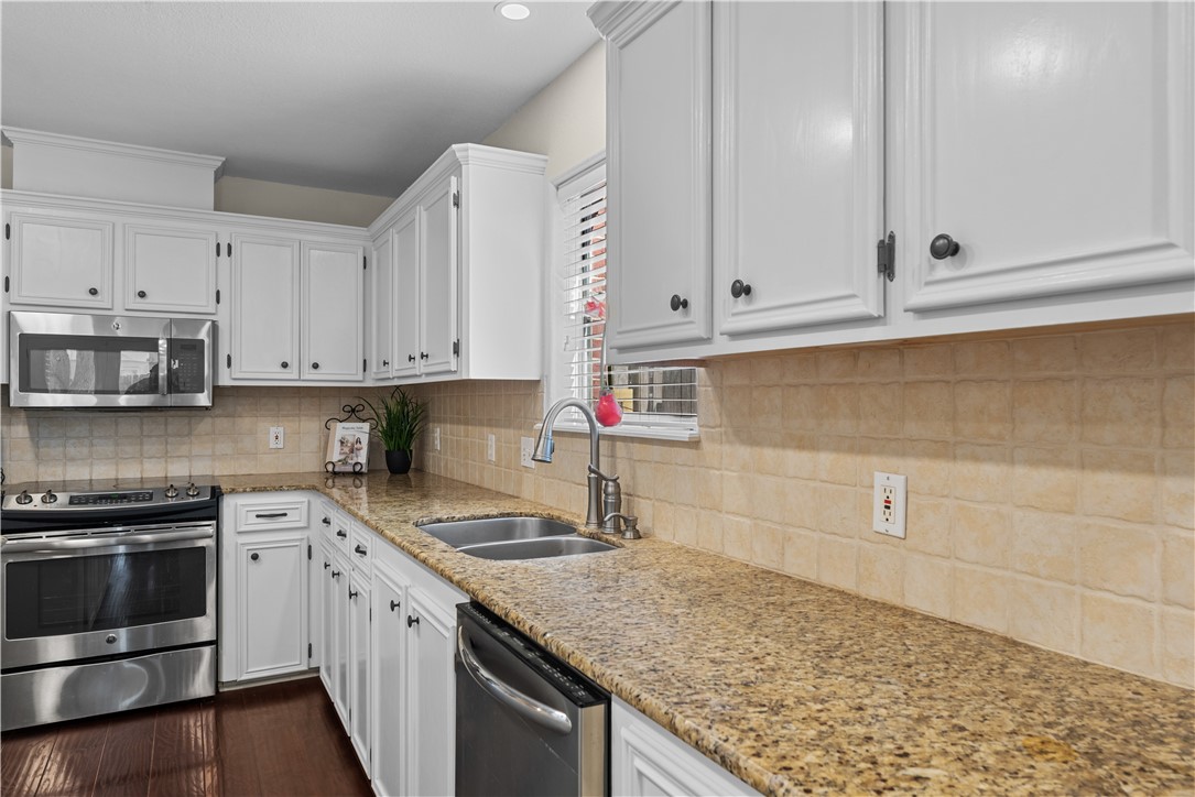 5117 Lethaby Drive Corpus Christi, TX 78413 - Photo 9 of 31 a kitchen with stainless steel appliances granite countertop a sink stove and cabinets