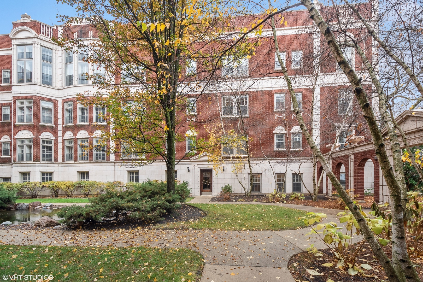 a view of a large brick building next to a yard