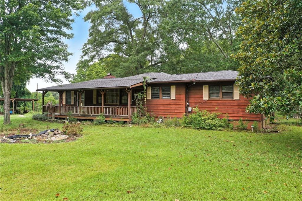 5780 Hill Road Southwest Powder Springs, GA 30127 - Photo 1 of 1 a front view of a house with garden