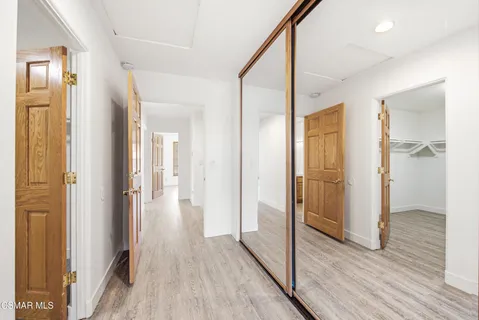 a view of hallway with wooden floor