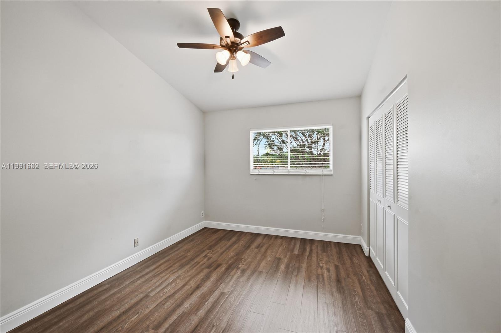 6215 Old Court Road, Unit 505 Boca Raton, FL 33433 - Photo 15 of 36 an empty room with wooden floor and ceiling fan