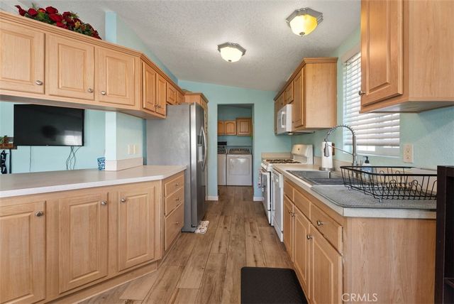 a kitchen with stainless steel appliances granite countertop a sink and cabinets