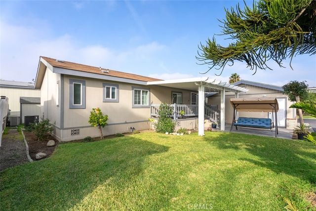 a front view of house with yard and outdoor seating