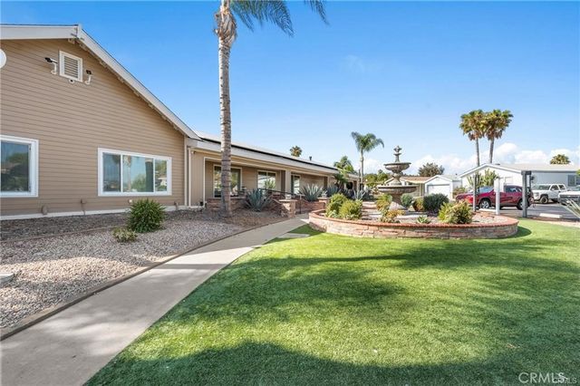 a view of swimming pool with lawn chairs and a potted plant