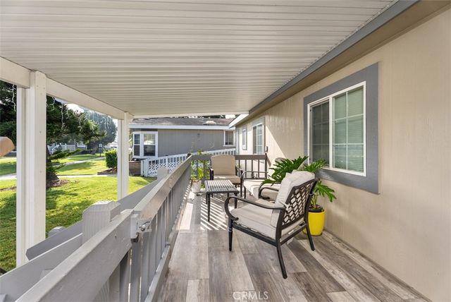 a balcony with furniture and a potted plant