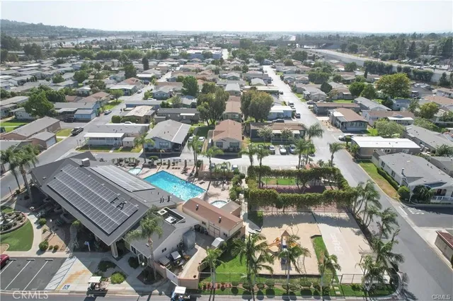 an aerial view of residential houses with city view