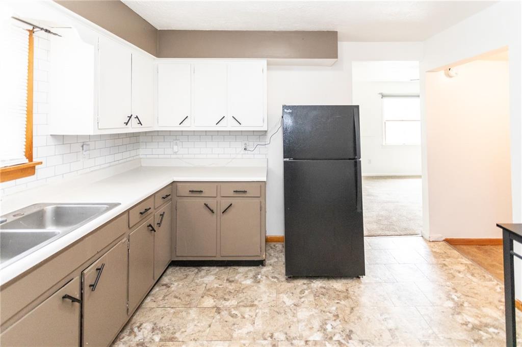 105 Jones Street Everson, PA 15631 - Photo 11 of 17 a kitchen with a sink a refrigerator and a cabinets