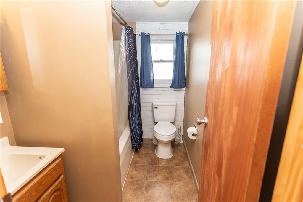105 Jones Street Everson, PA 15631 - Photo 17 of 17 a bathroom with a toilet a sink and a window