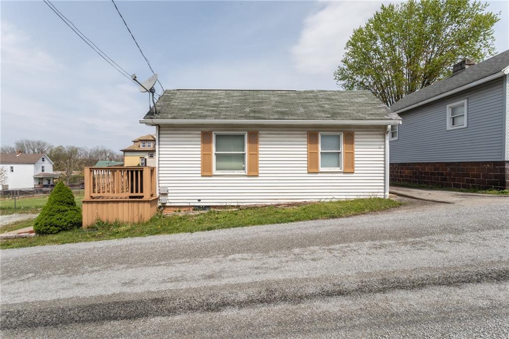 105 Jones Street Everson, PA 15631 - Photo 3 of 17 a front view of a house with a yard and garage