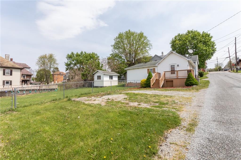105 Jones Street Everson, PA 15631 - Photo 5 of 17 a front view of a house with garden