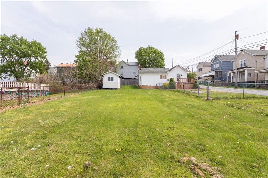 105 Jones Street Everson, PA 15631 - Photo 6 of 17 a view of a house with a big yard and large trees