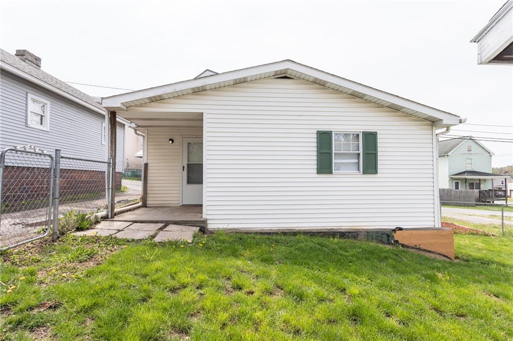 105 Jones Street Everson, PA 15631 - Photo 7 of 17 a front view of a house with a yard