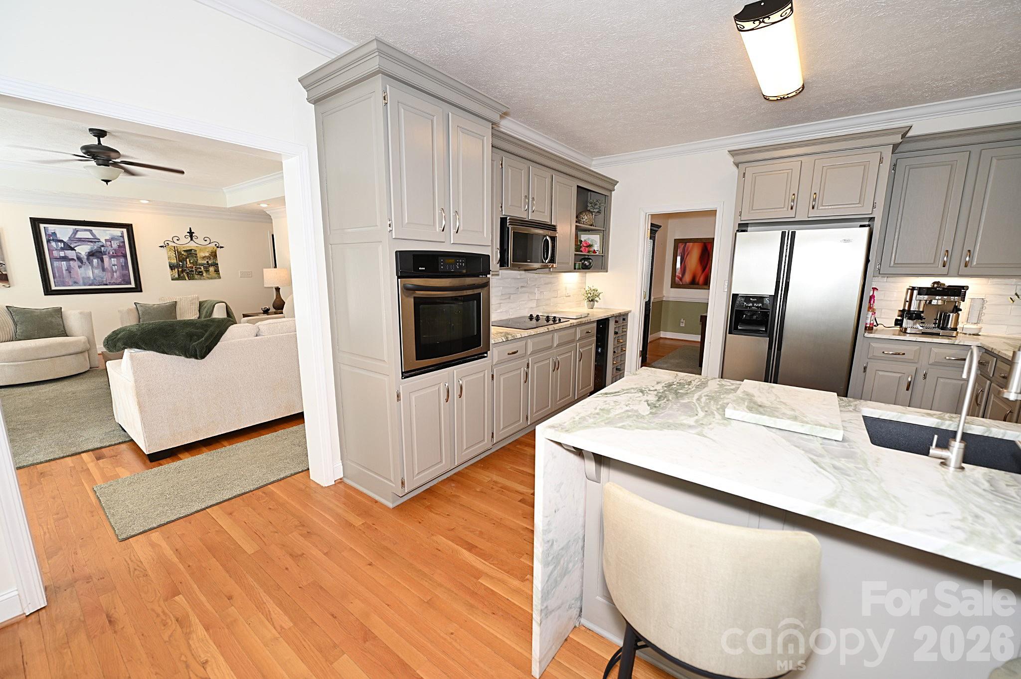 406 5th Avenue Northeast Conover, NC 28613 - Photo 22 of 46 a kitchen with stainless steel appliances kitchen island granite countertop a refrigerator a stove and a sink with dishwasher