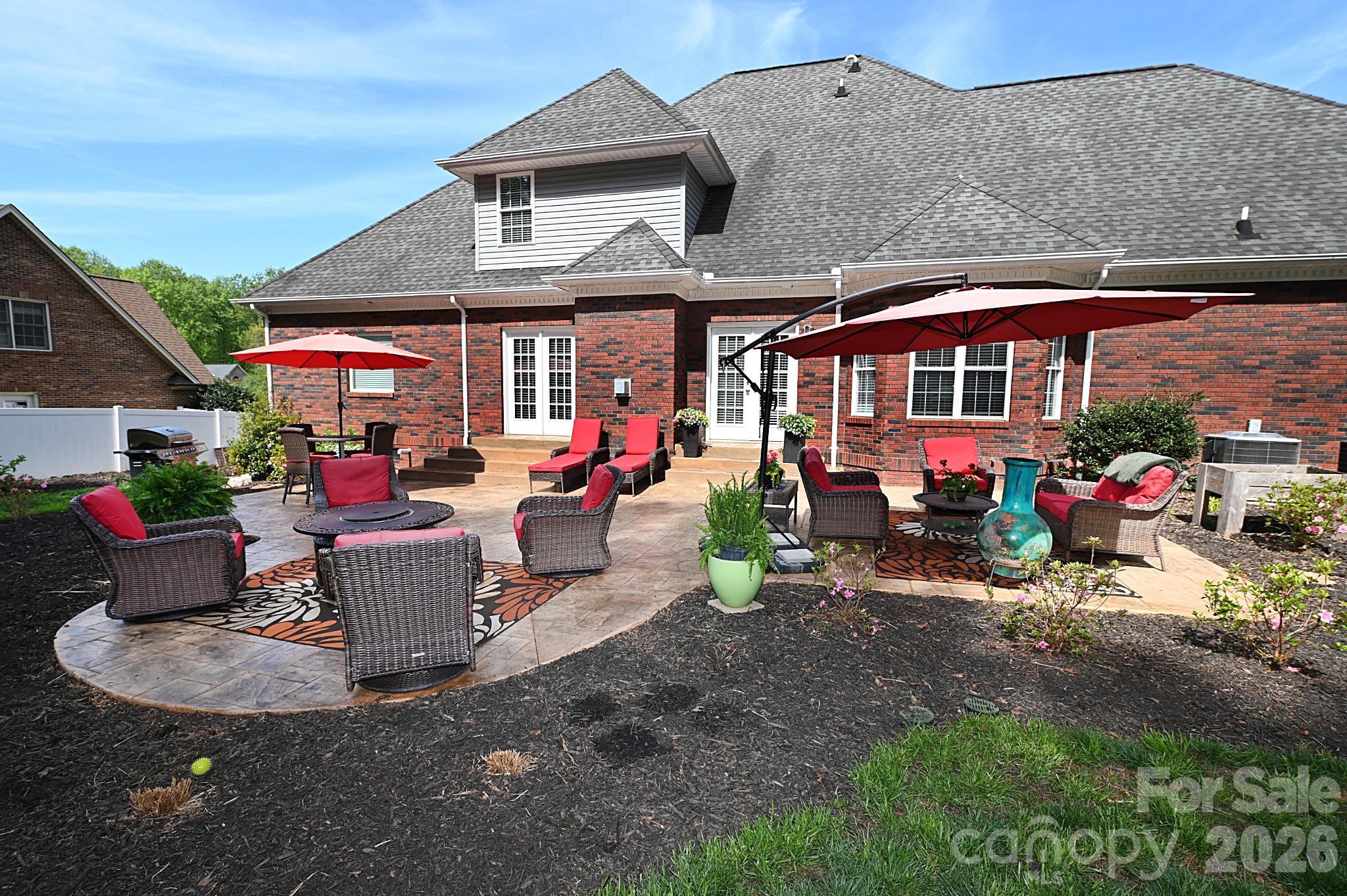 406 5th Avenue Northeast Conover, NC 28613 - Photo 40 of 46 a view of a patio with table and chairs under an umbrella