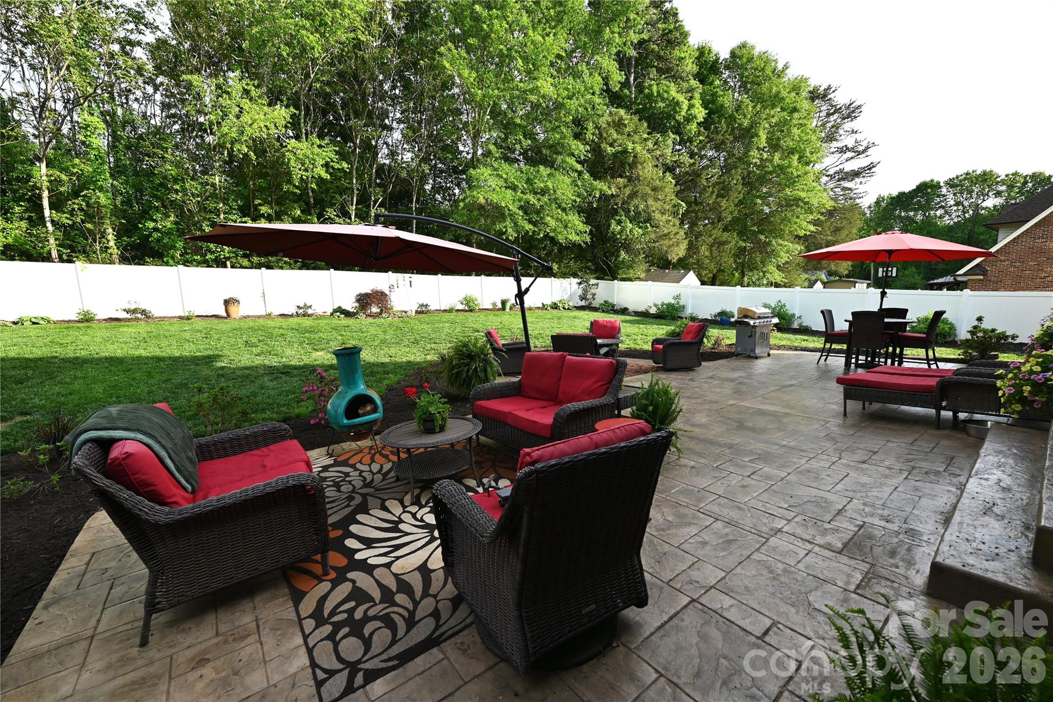 406 5th Avenue Northeast Conover, NC 28613 - Photo 4 of 46 a view of a patio with couches table and chairs under an umbrella