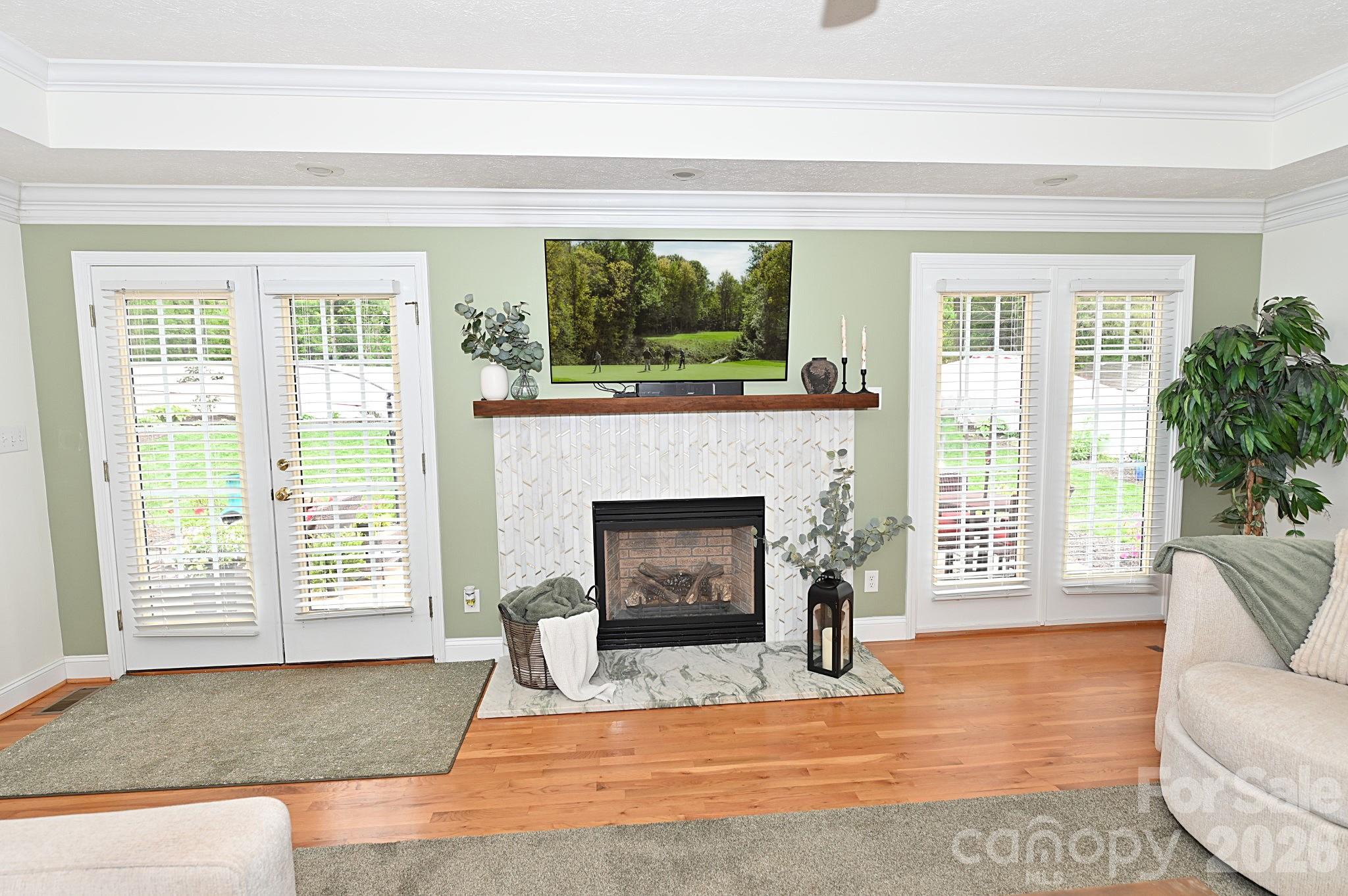 406 5th Avenue Northeast Conover, NC 28613 - Photo 10 of 46 a living room with a fireplace and a floor to ceiling window
