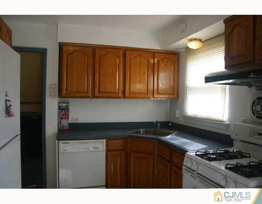 18 Wilshire Road Edison, NJ 08817 - Photo 5 of 10 a kitchen with kitchen island granite countertop a sink cabinets and stainless steel appliances