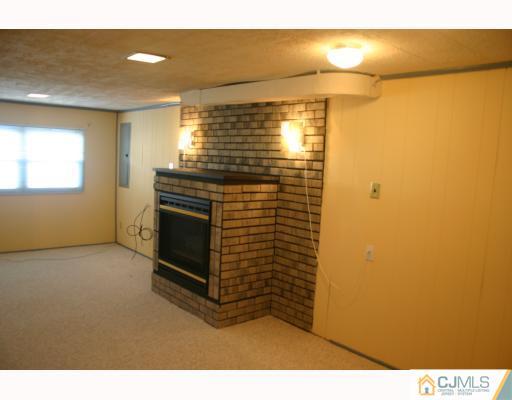 18 Wilshire Road Edison, NJ 08817 - Photo 7 of 10 a view of empty room with window and fireplace