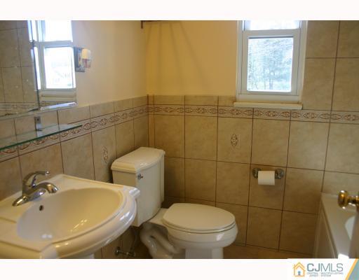 18 Wilshire Road Edison, NJ 08817 - Photo 8 of 10 a bathroom with a sink mirror and toilet