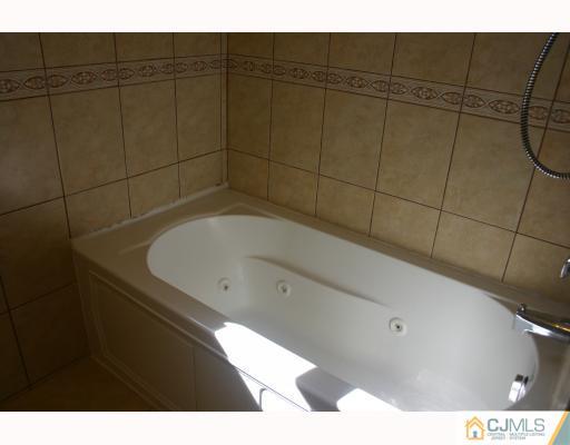18 Wilshire Road Edison, NJ 08817 - Photo 9 of 10 a bathroom with a bathtub
