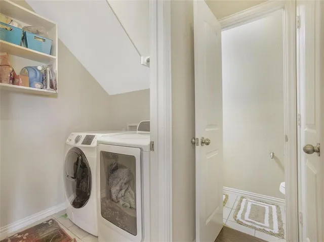 a view of storage and utility room with washer and dryer