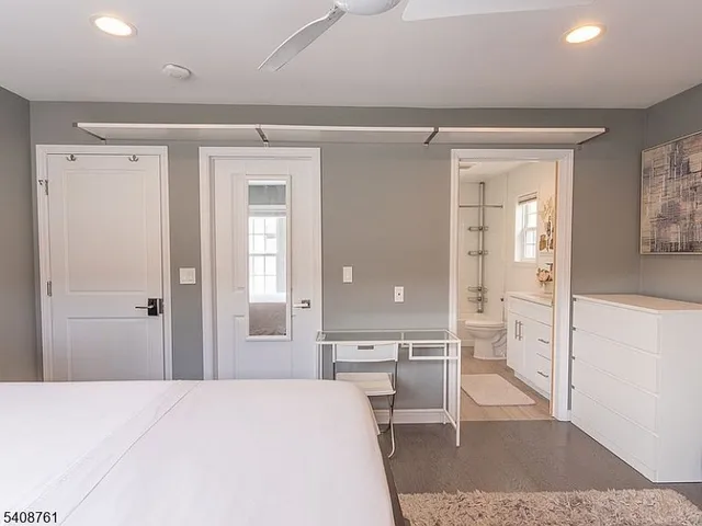 a large bedroom with a bed and glass door