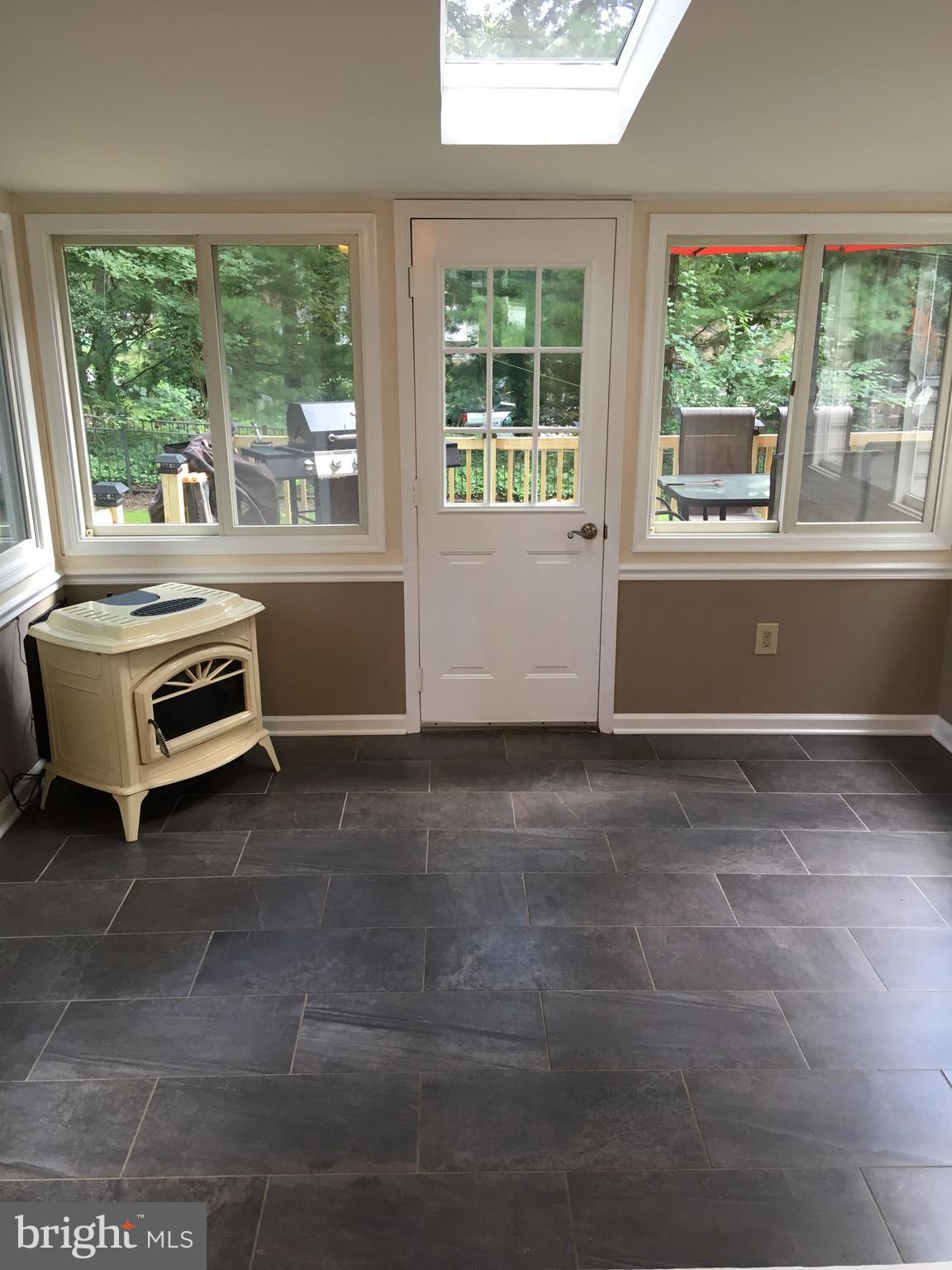 1523 Long Point Road Pasadena, MD 21122 - Photo 23 of 25 Pellet Stove in Florida Room - Great Home Office