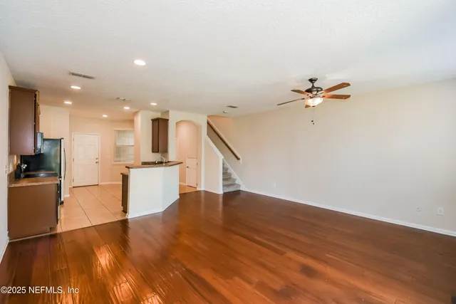 a view of a kitchen with wooden floor and a sink