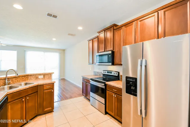 a kitchen with stainless steel appliances a refrigerator stove and sink