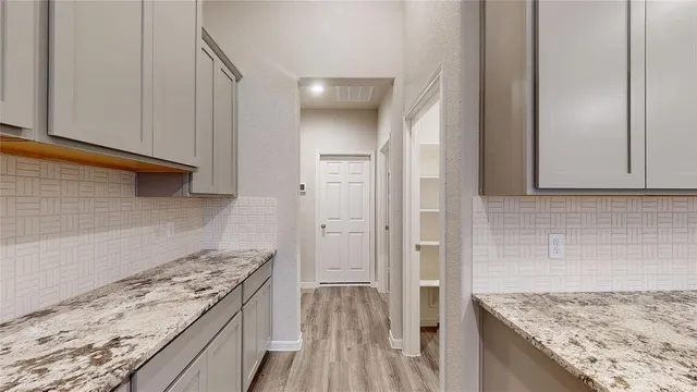 a kitchen with a stove and a granite counter tops