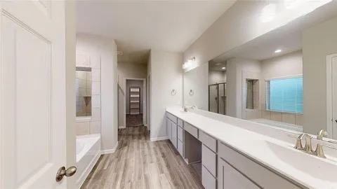 a large bathroom with a double vanity sink and a mirror