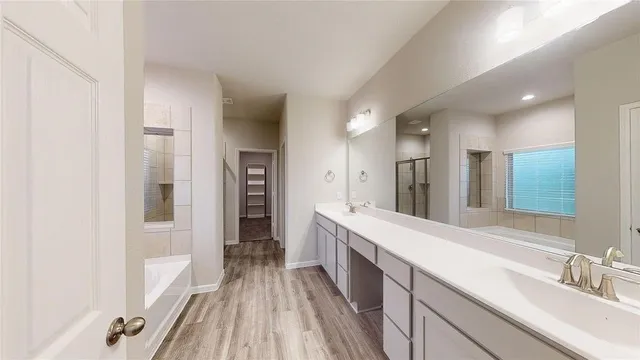 a large bathroom with a double vanity sink and a mirror
