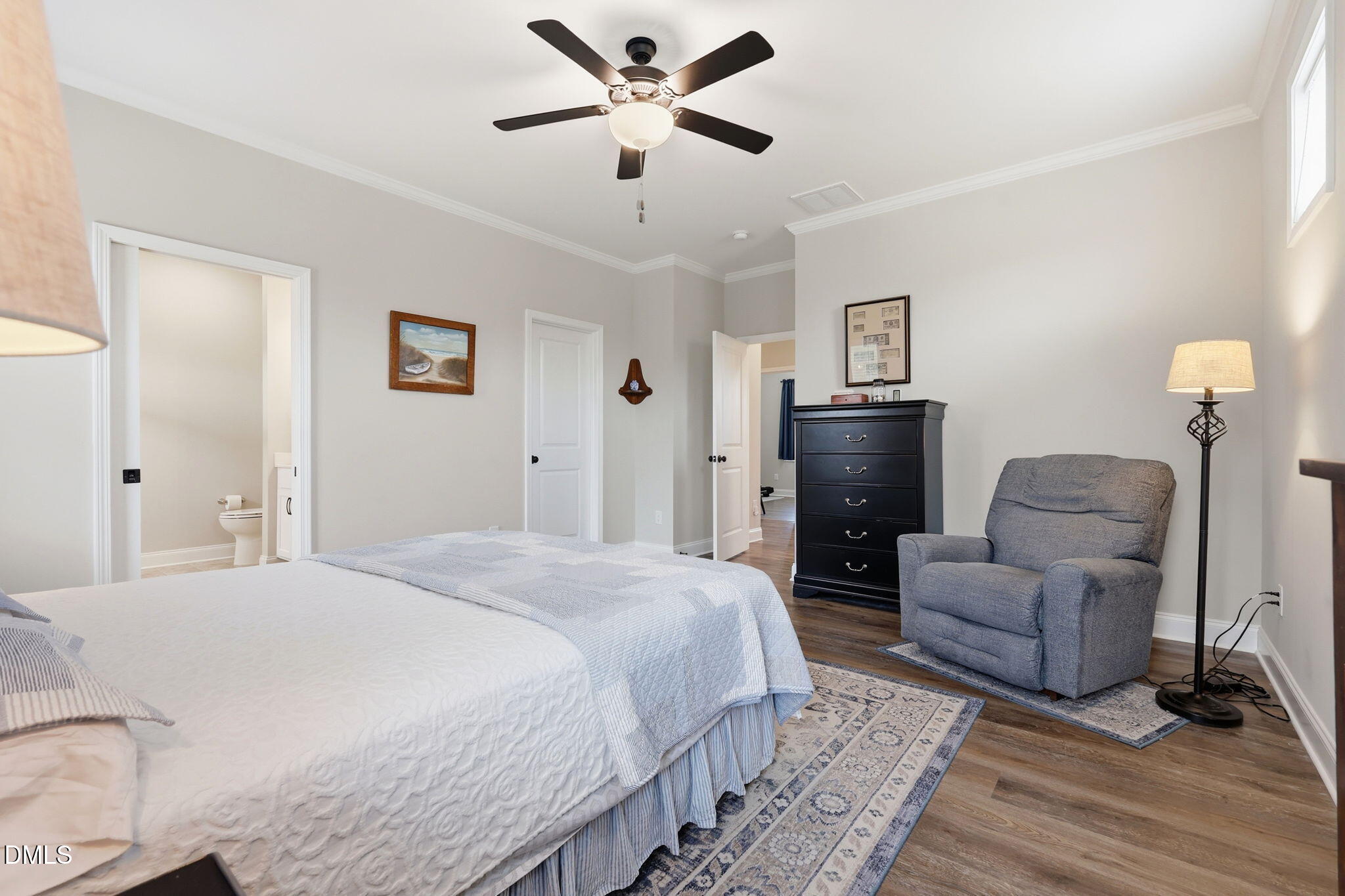 5098 Spring Hill Church Road Lillington, NC 27546 - Photo 15 of 36 a spacious bedroom with a bed and a chandelier