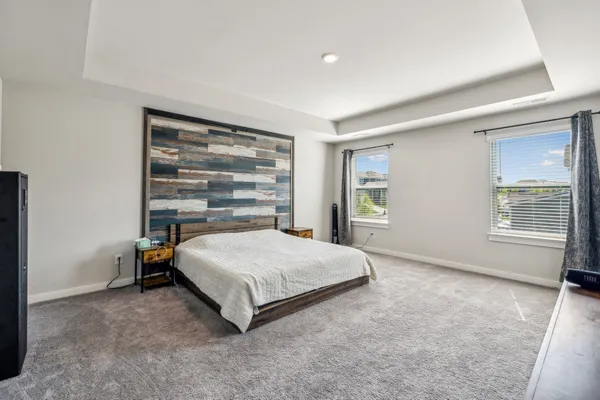 a spacious bedroom with a bed and closet