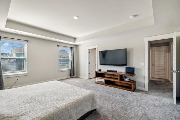 a bedroom with furniture and flat screen tv