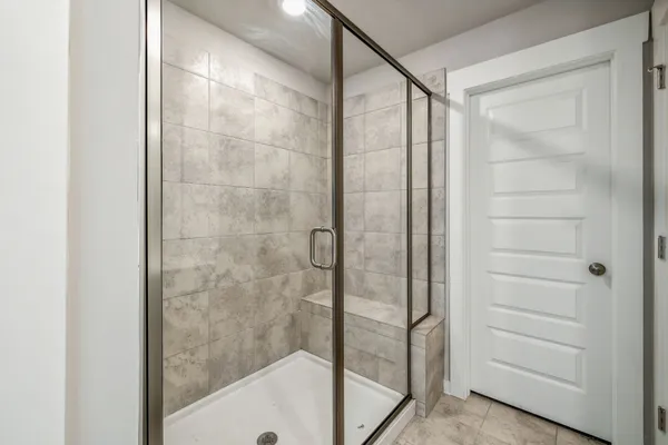 a bathroom with a glass shower door