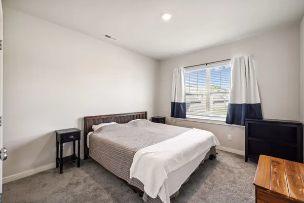 a bedroom with a bed and window