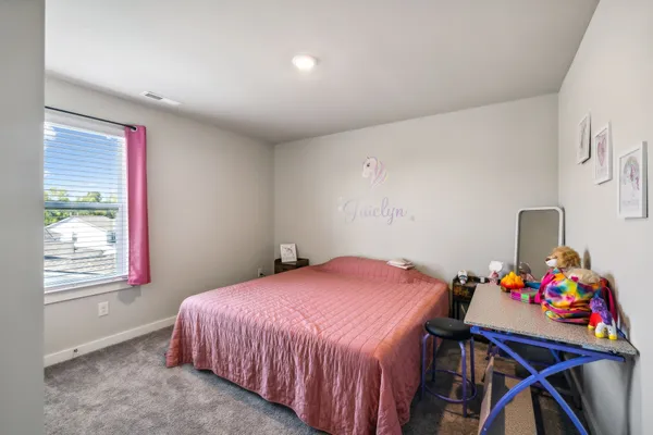 a bedroom with a bed and a table in it
